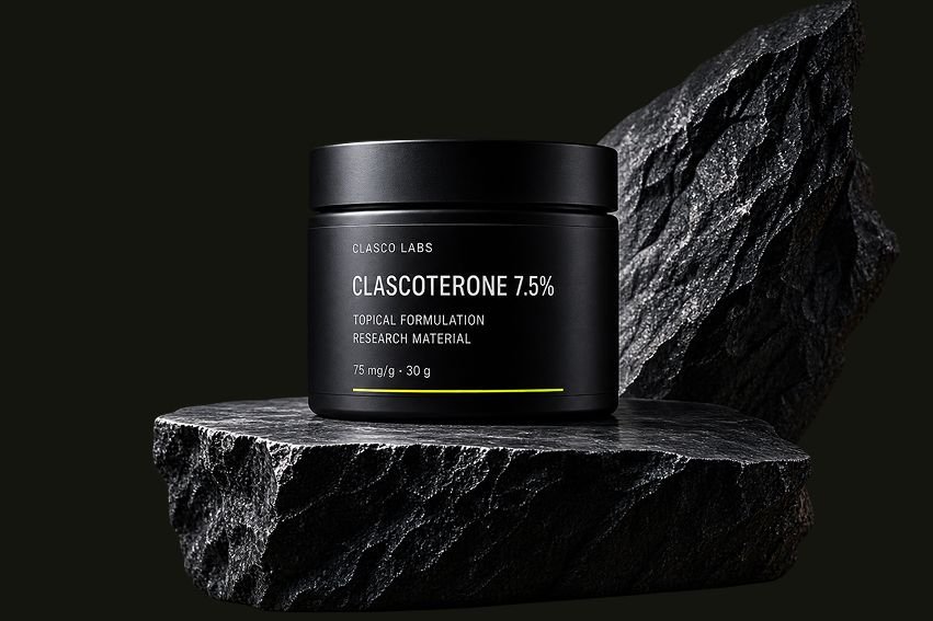 Clascoterone 7.5% jar photographed on dark slate under studio lighting
